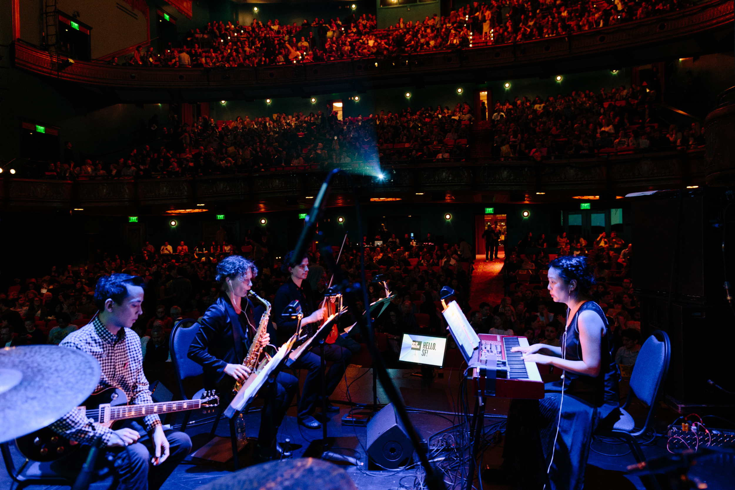 Magik*Magik Orchestra performs in front of a live audience.