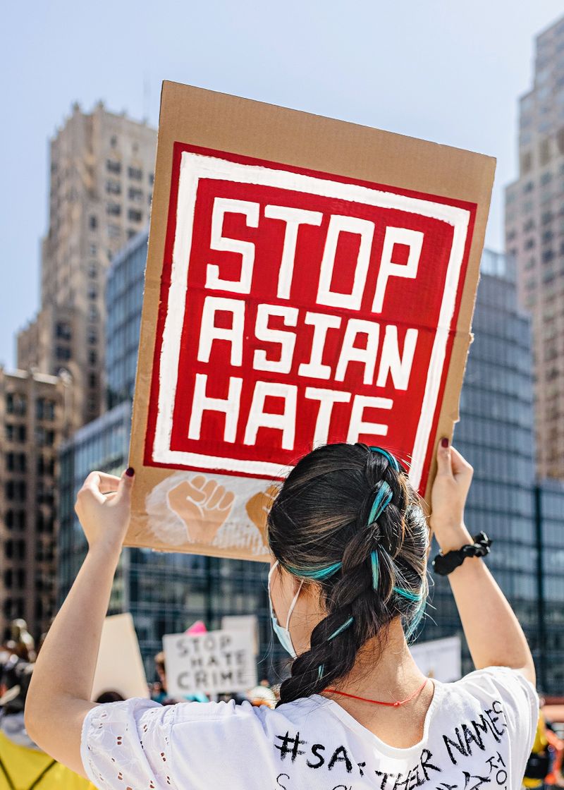 A woman holds up a sign