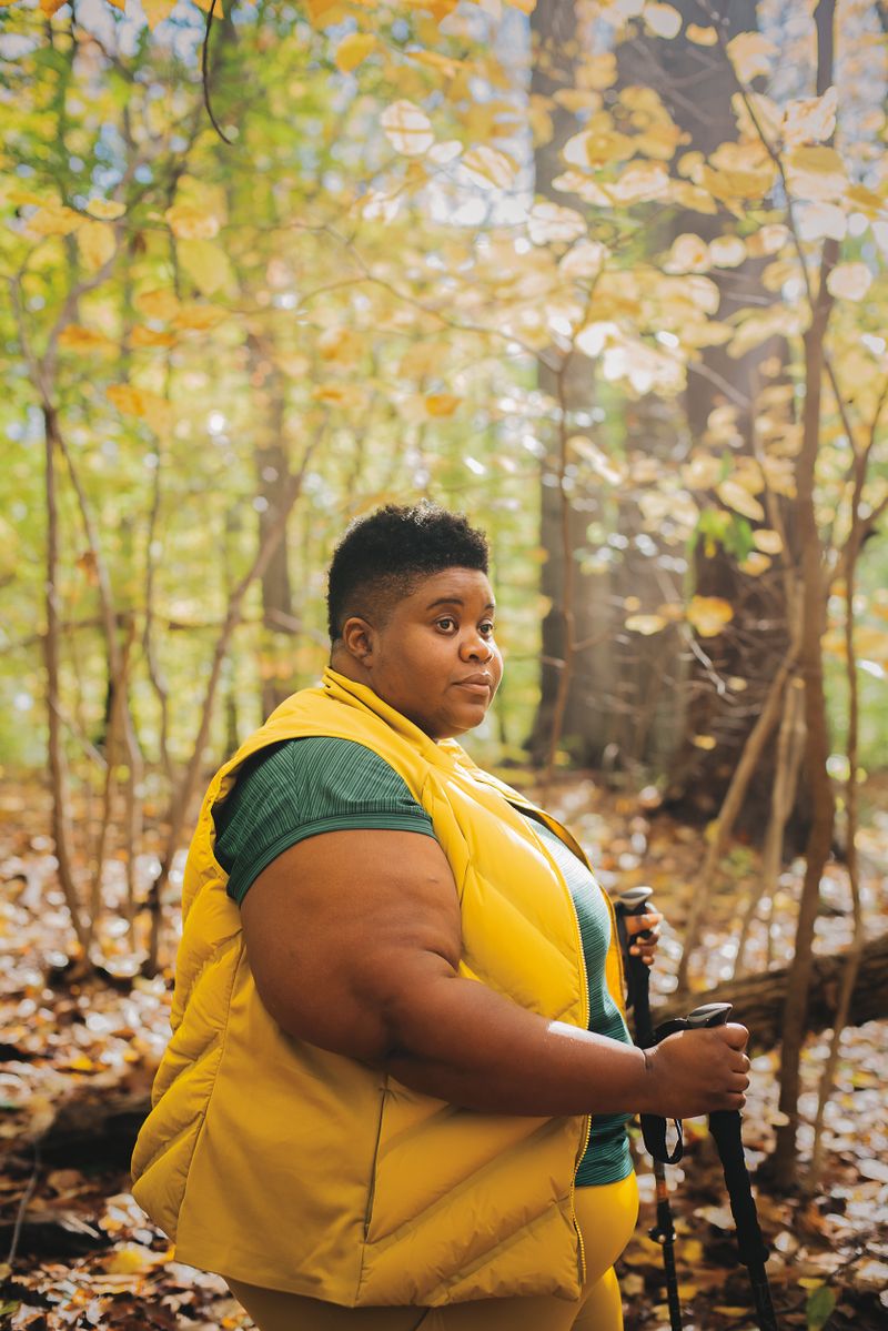 A woman in profile in the woods.